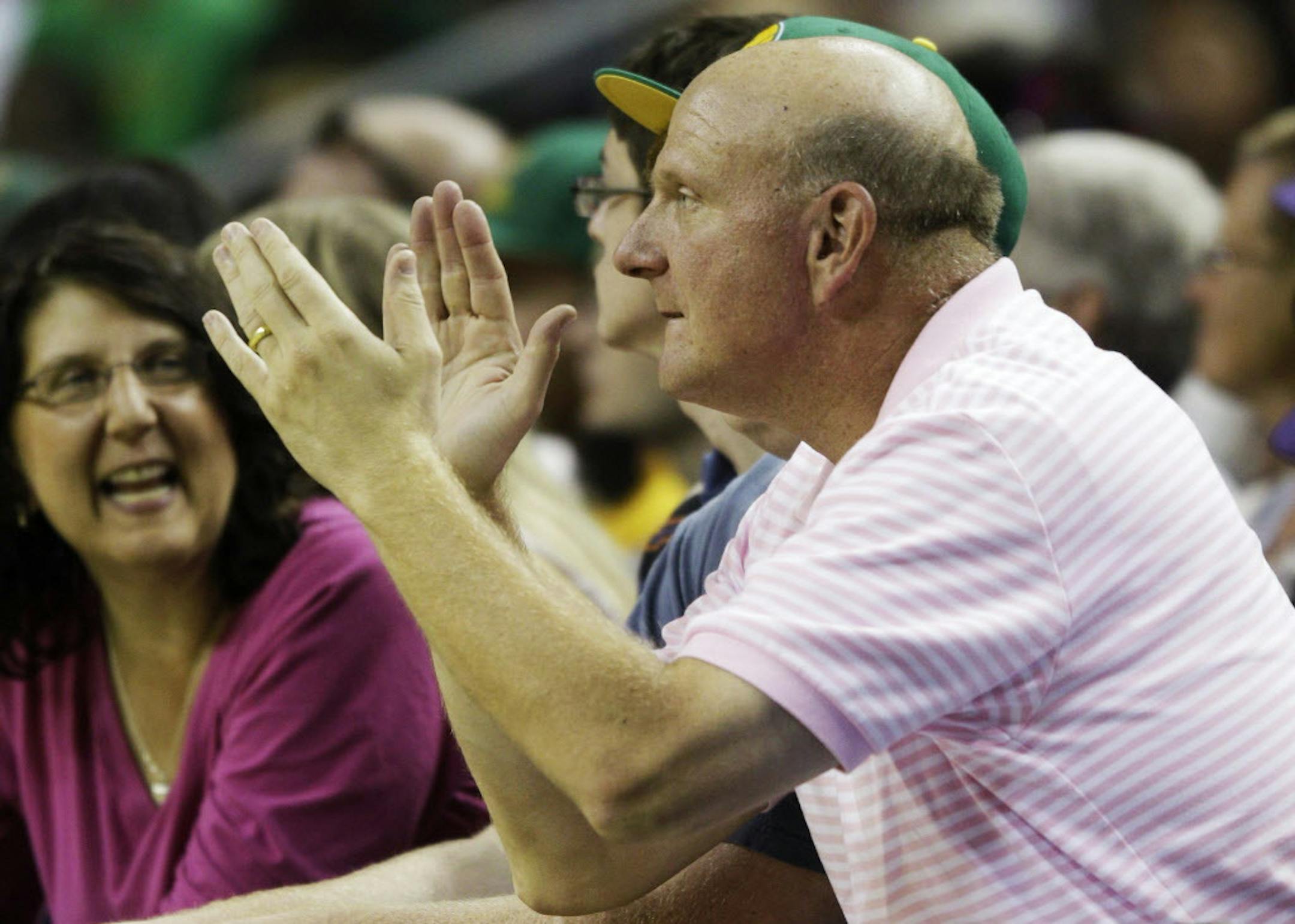 FILE - In this July 23, 2011 file photo, Microsoft Corp. CEO Steve Ballmer cheers during a charity basketball game in Seattle. For decades, Steve Ballmer has been Microsoft's biggest cheerleader with his big, booming voice and energetic high-fives, which are famous around Seattle. Now that heís agreed to buy the Los Angeles Clippers for $2 billion, the former CEO of the technology giant is expected to bring that boosterism to the hardwood down south. (AP Photo/Ted S. Warren, File)