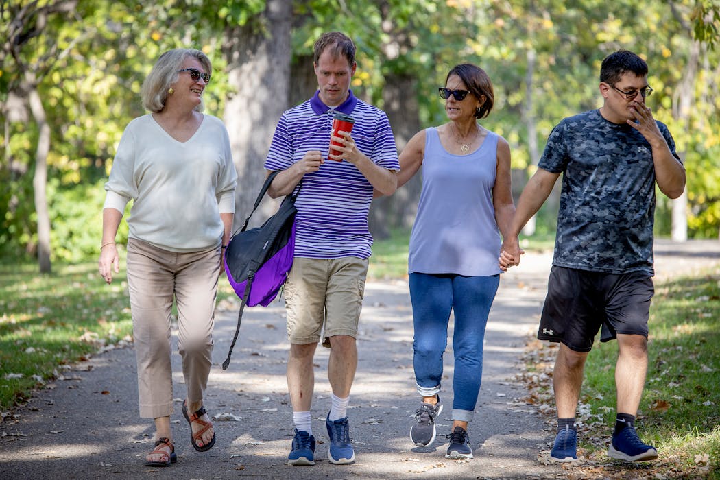 Rose Fagrelius, and her son John, left, were joined by Pat Leseman and her son Michael, right, for a walk along the river in St. Paul. The women started the Highland Friendship Club as a way for their sons to make friends and stay active.