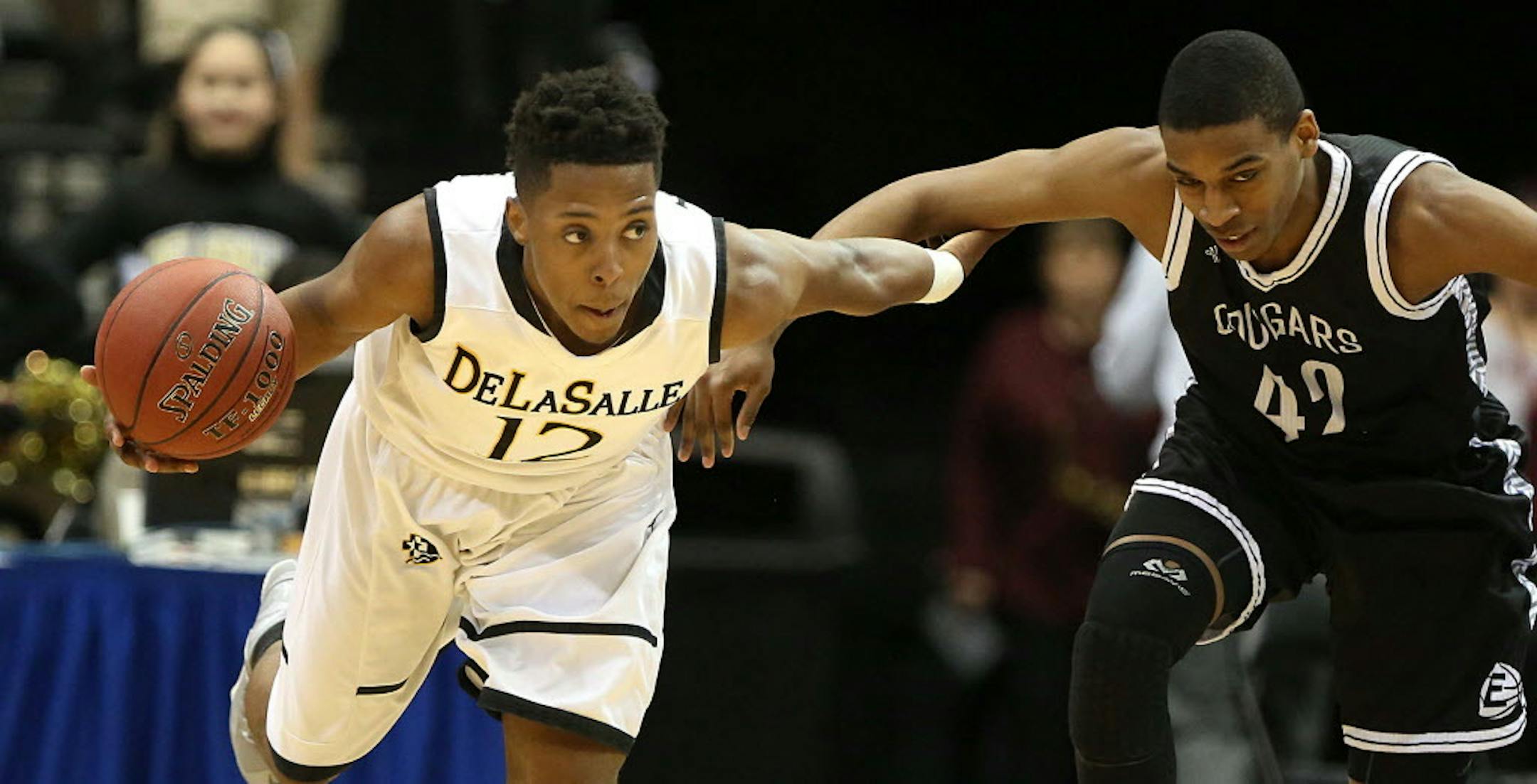 DeLaSalle�s Jarvis Johnson (left) took control of the ball against Mankato East�s CJ Ayers in the first half. ]JIM GEHRZ � james.gehrz@startribune.com / Minneapolis, MN / March 12, 2015 /12:00 PM � BACKGROUND INFORMATION: The DeLaSalle High School Islanders played the Mankato East Cougars in the State Boys' Basketball Tournament Class 3A semifinals at the Target Center. ORG XMIT: MIN1503121320122976