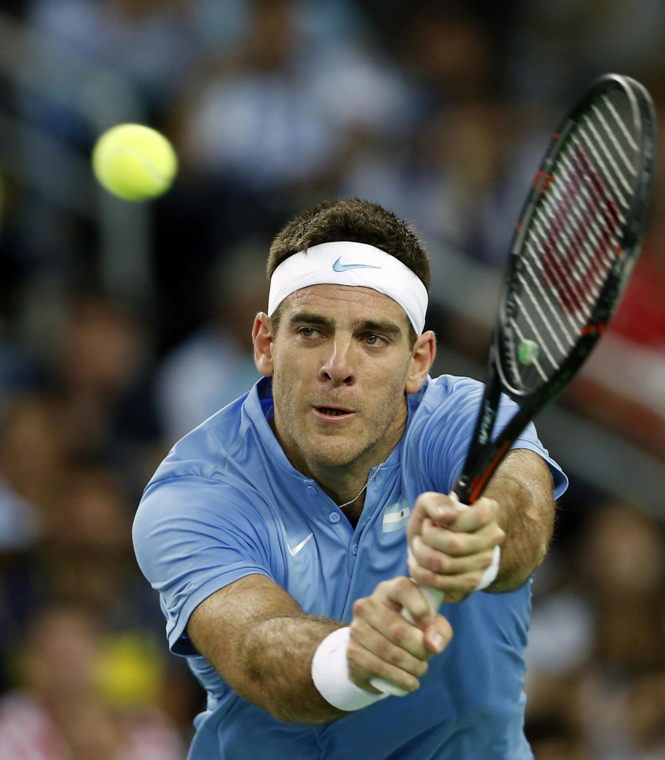 Argentina's Juan Martin Del Potro returns a ball to Croatia's Ivo Karlovic during their singles match at the Davis Cup tennis tournament final between the two countries in Zagreb, Croatia, Friday, Nov. 25, 2016. (AP Photo/Darko Vojinovic)