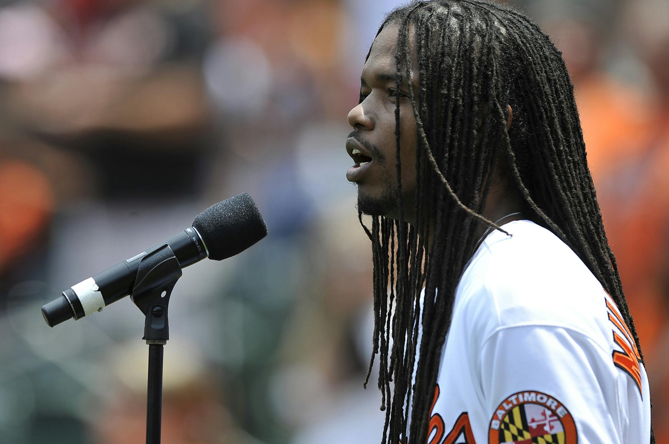 Jazz singer Landau Eugene Murphy, Jr. sings the National Anthem before the Baltimore Orioles and Tampa Bay Rays baseball game, Sunday, June 29, 2014, in Baltimore.(AP Photo/Gail Burton) ORG XMIT: OTKS105