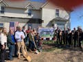 Organizers and supporters of the Bravo Zulu House celebrate a groundbreaking of the novel veterans sober living project in Winnebago, Minn., Wednesday