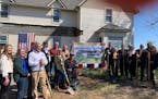 Organizers and supporters of the Bravo Zulu House celebrate a groundbreaking of the novel veterans sober living project in Winnebago, Minn., Wednesday