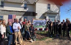 Organizers and supporters of the Bravo Zulu House celebrate a groundbreaking of the novel veterans sober living project in Winnebago, Minn., Wednesday