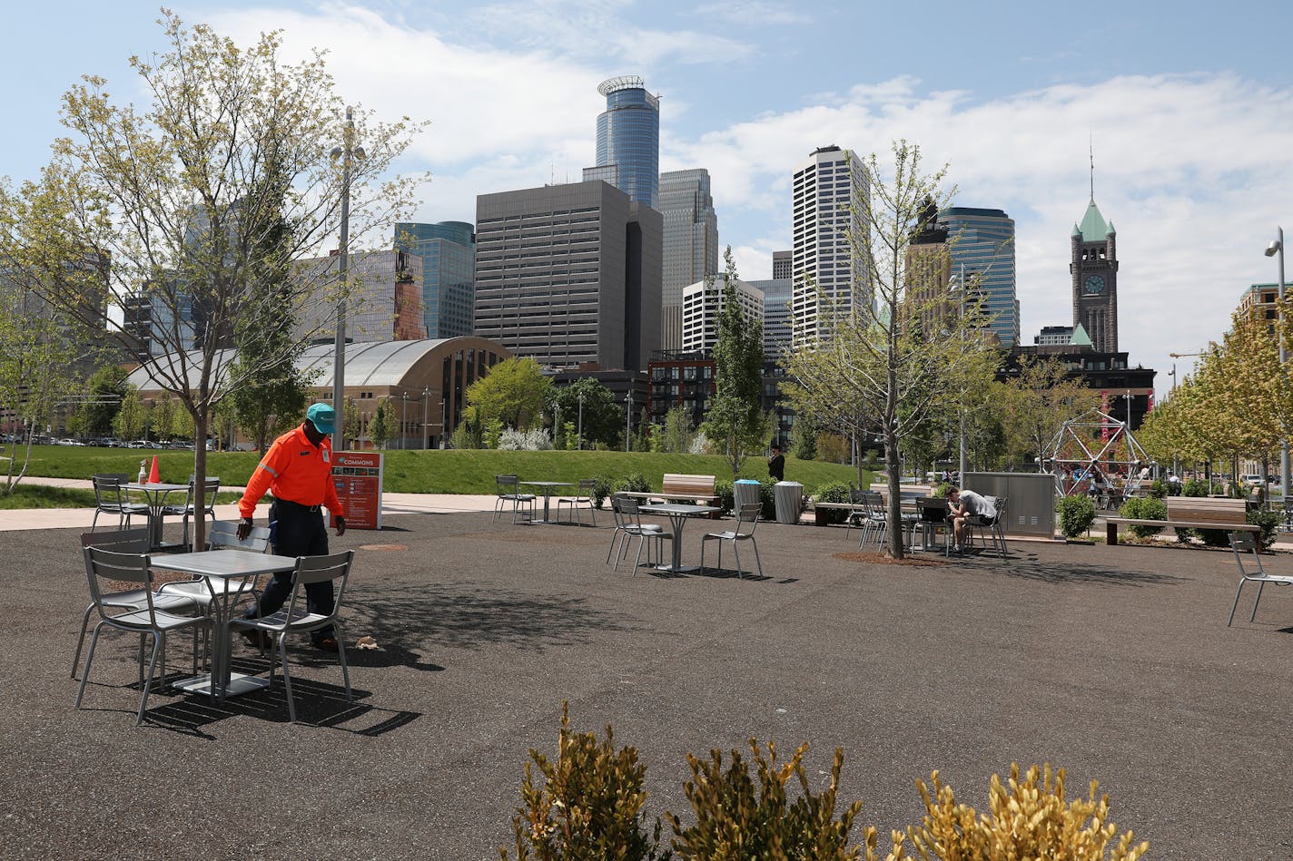 Commons host Otis Johnson re-positioned tables and chairs Friday. ] ANTHONY SOUFFLE &#xef; anthony.souffle@startribune.com Visitors enjoyed the warm weather Friday, May 12, 2017 at Downtown East Commons in Minneapolis. The park opened nearly a year ago, but this is the first summer that visitors will be able to take full advantage of the downtown Minneapolis park. Green Minneapolis, the nonprofit conservancy that manages Downtown East, has planned a season's worth of daily and one-time attractio