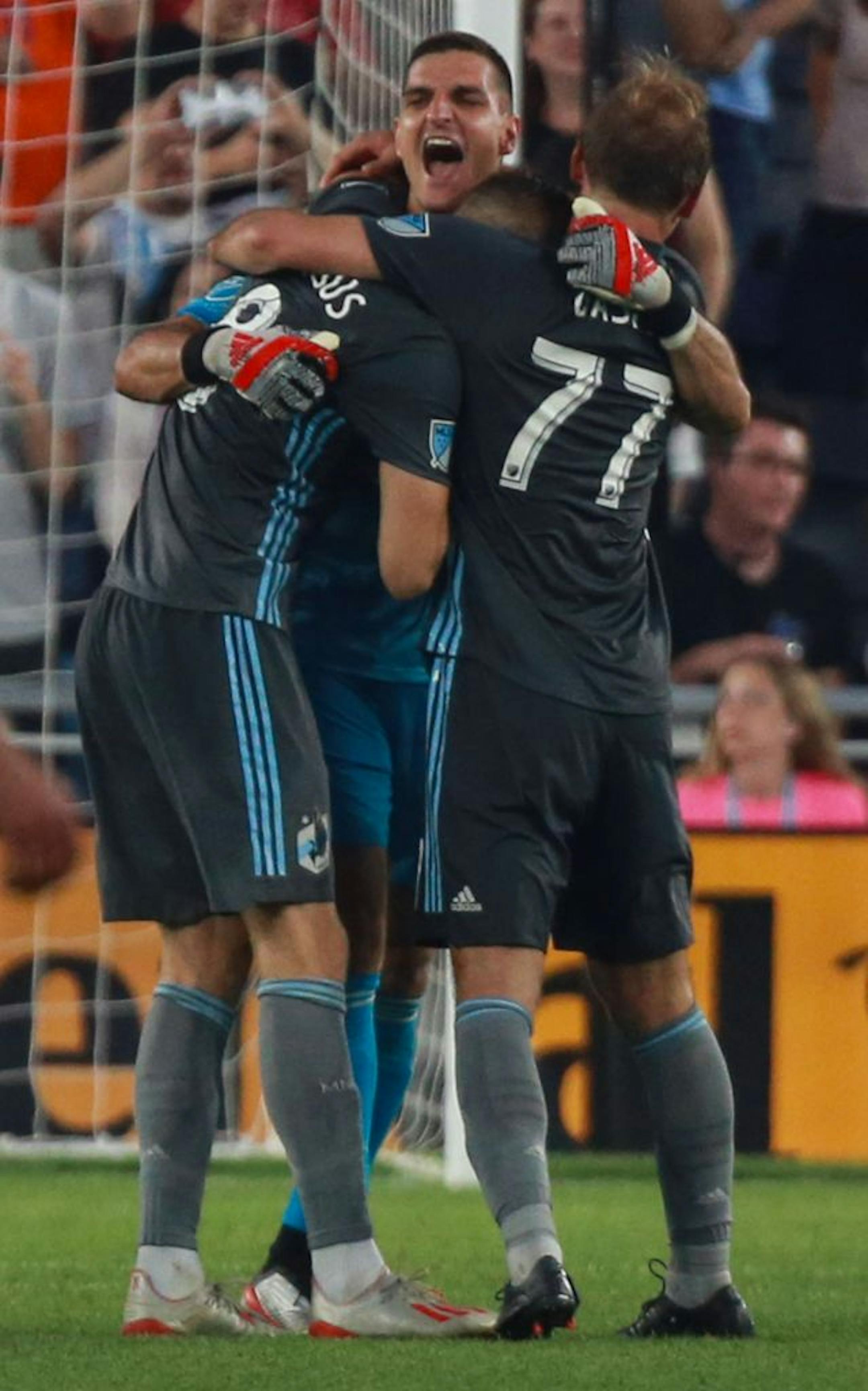 Vito Mannone (1), Jan Gergus (8) and Chase Gasper (77) embrace after Mannone made a game sealing save on a penalty kick in stoppage time. ALEX KORMANN ¥ alex.kormann@startribune.com The Minnesota United FC took on FC Dalls on Saturday July 13, 2019 at Allianz Field in St. Paul, MN.