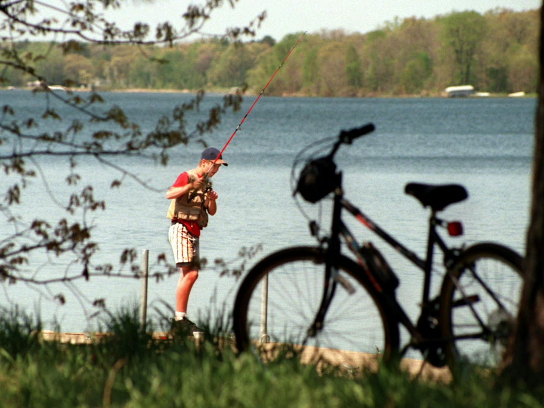 TONY MANIFOLD, 14, OF CENTER NORTH NORTH DAKOTA, PULLED OFF THE PAUL BUNYAN TRAIL WITH HIS BIKE TO FISH FOR CRAPPIES IN NORTH LONG LAKE. ORG XMIT: MIN2014071414484643