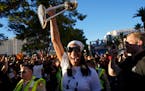 Las Vegas Aces forward A'ja Wilson holds up the trophy during a rally to celebrate the Las Vegas Aces' basketball championship, Tuesday, Sept. 20, 202