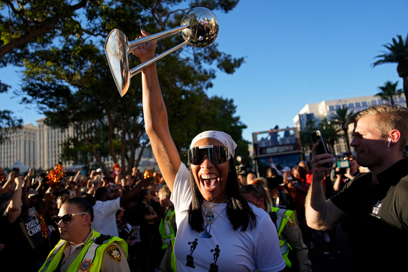 Las Vegas Aces forward A'ja Wilson holds up the trophy during a rally to celebrate the Las Vegas Aces' basketball championship, Tuesday, Sept. 20, 2022, in Las Vegas. (AP Photo/John Locher)