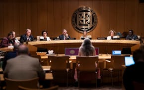 University of Minnesota Regents listen to comments from Nora Livesay, a professor in American Indian Studies, during a public forum Thursday about the