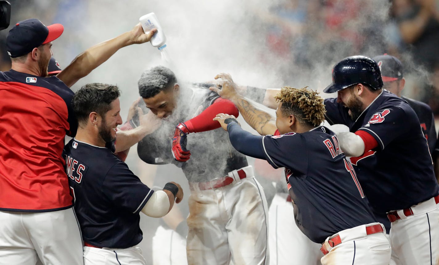 Francisco Lindor, center, is welcomed by teammates after he hit a walk-off three-run home run against the Twins on Wednesday.