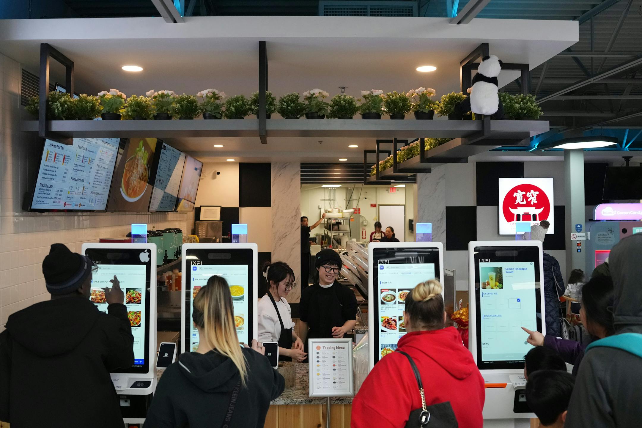 Customers place electronic orders at Legendary Spice in the new Asia Mall.