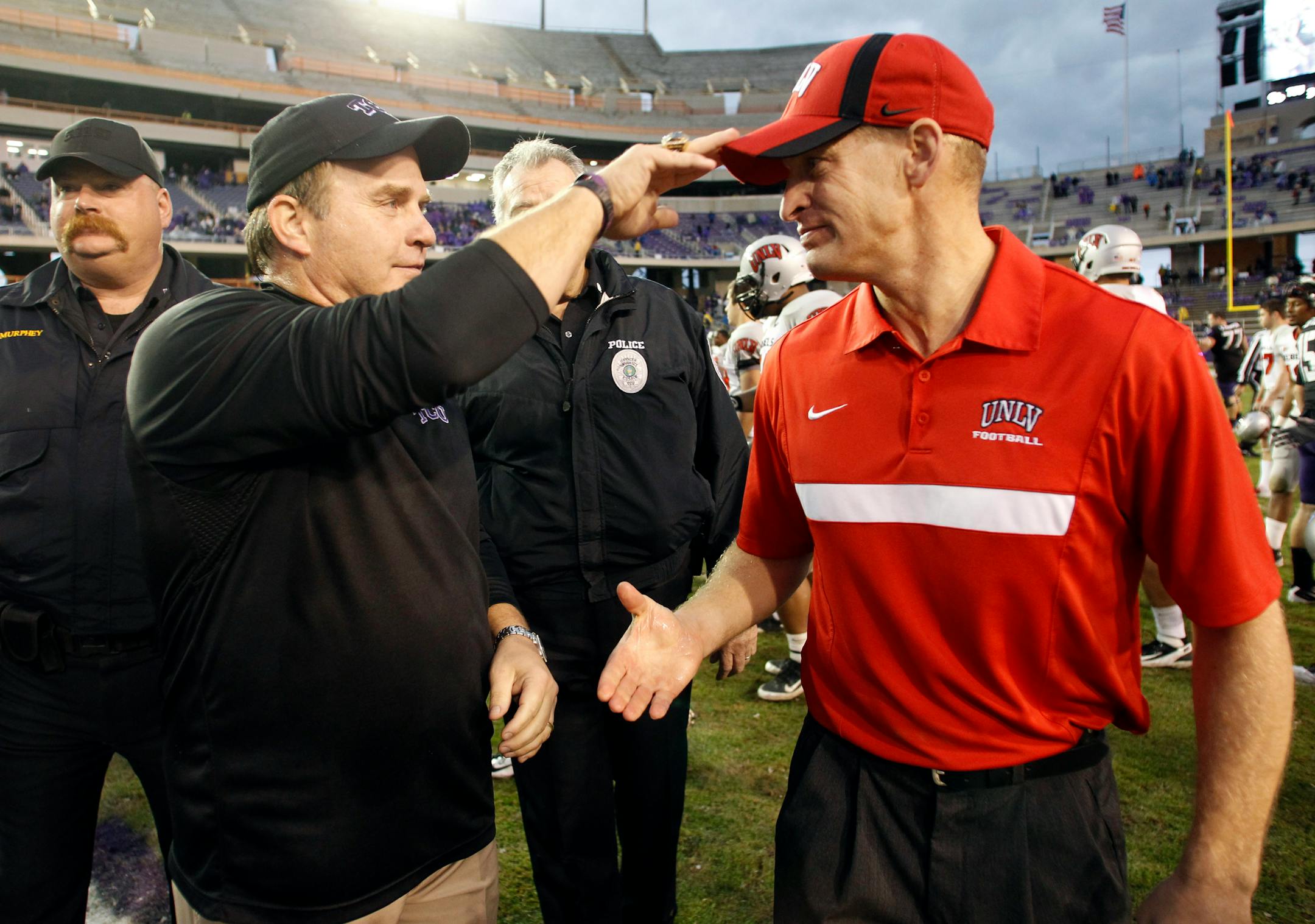 Texas Christian head coach Gary Patterson and UNLV head coach Bobby Hauck meet at midfield at the end of the game at Amon Carter Stadium in Fort Worth, Texas, Saturday, December 3, 2011. TCU defeated UNLV, 56-9. (Sharon Ellman/Fort Worth Star-Telegram/MCT)