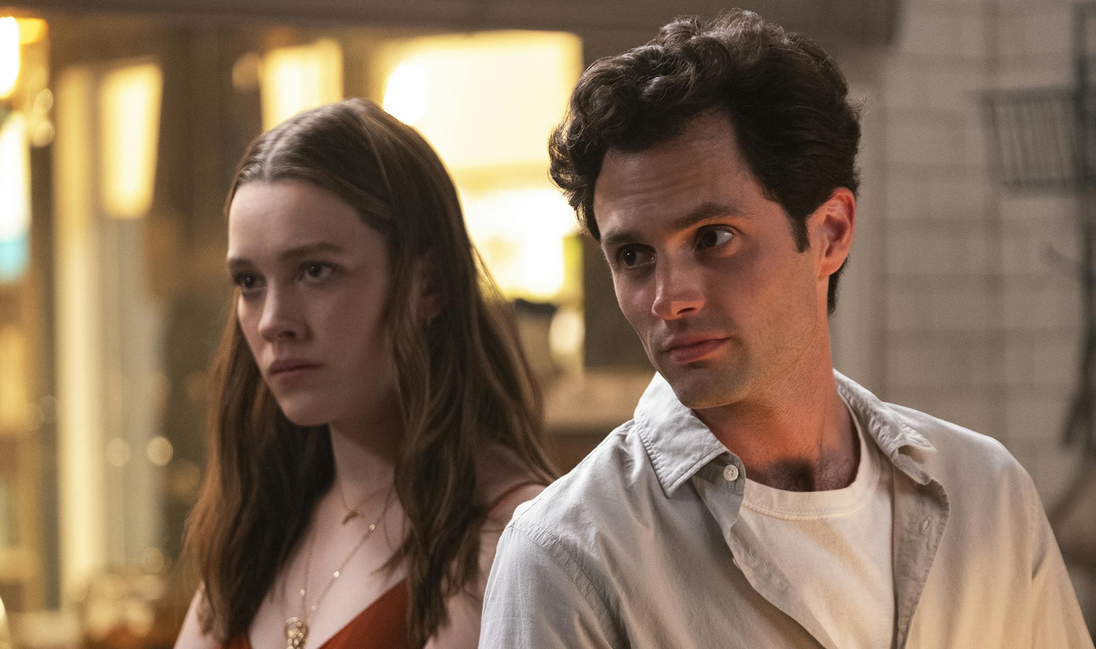Victoria Pedretti and Penn Badgley in "You."