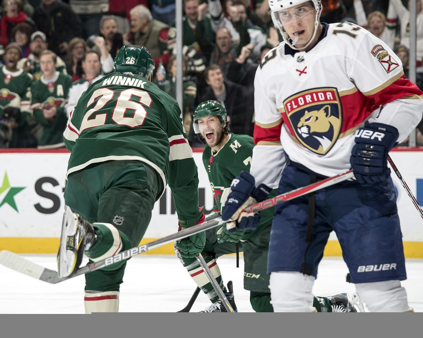 Mark Pysyk (13) skated away as Matt Cullen (7) celebrated after scoring a goal in the first period. ] CARLOS GONZALEZ &#xef; cgonzalez@startribune.com - January 2, 2018, St. Paul, MN, Xcel Energy Center, NHL, Hockey, Minnesota Wild vs. Florida Panthers