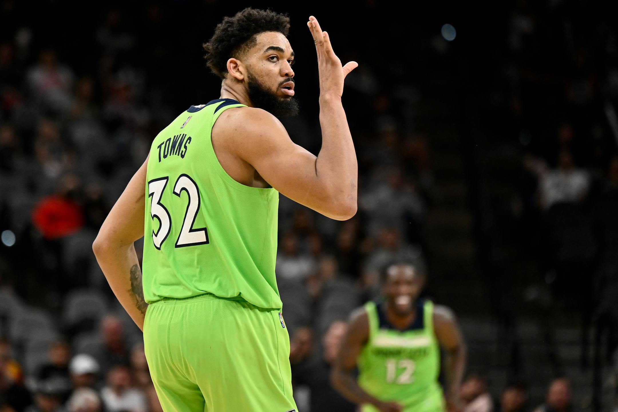 Minnesota Timberwolves' Karl-Anthony Towns celebrates a 3-point basket late in the second half of an NBA basketball game against the San Antonio Spurs on Monday, March 14, 2022, in San Antonio. (AP Photo/Darren Abate)