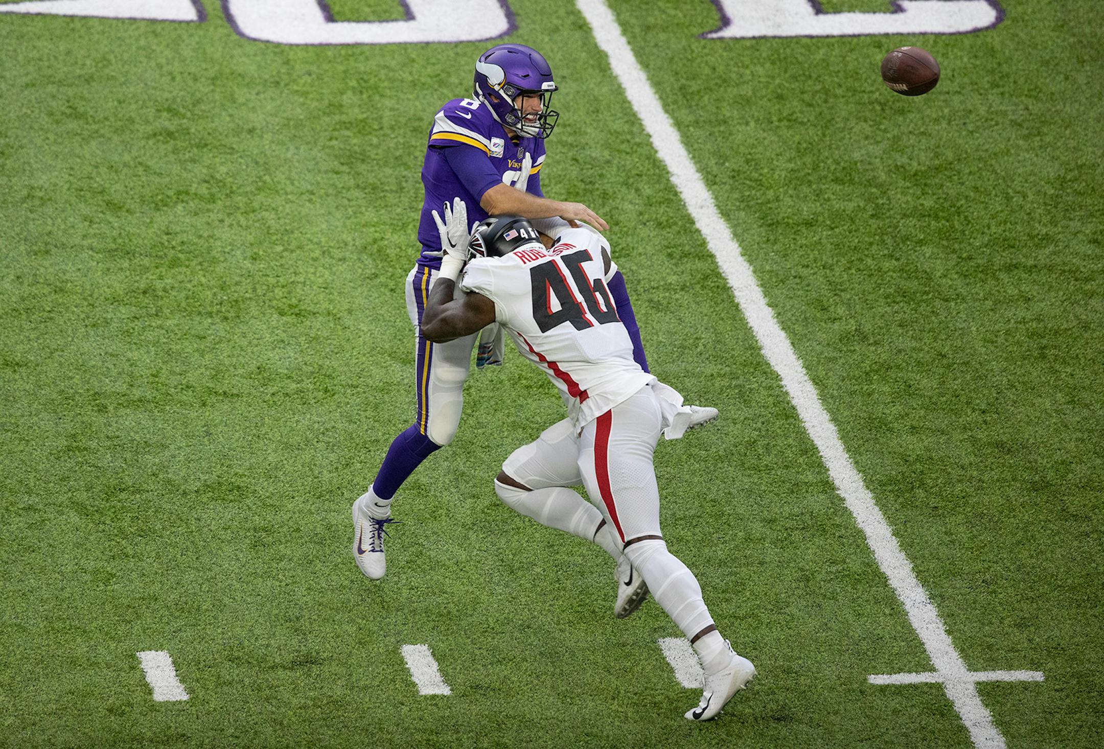 Minnesota Vikings quarterback Kirk Cousins (8) was hit by Atlanta Falcons linebacker Edmond Robinson (46) in the first quarter forcing an incomplete pass.