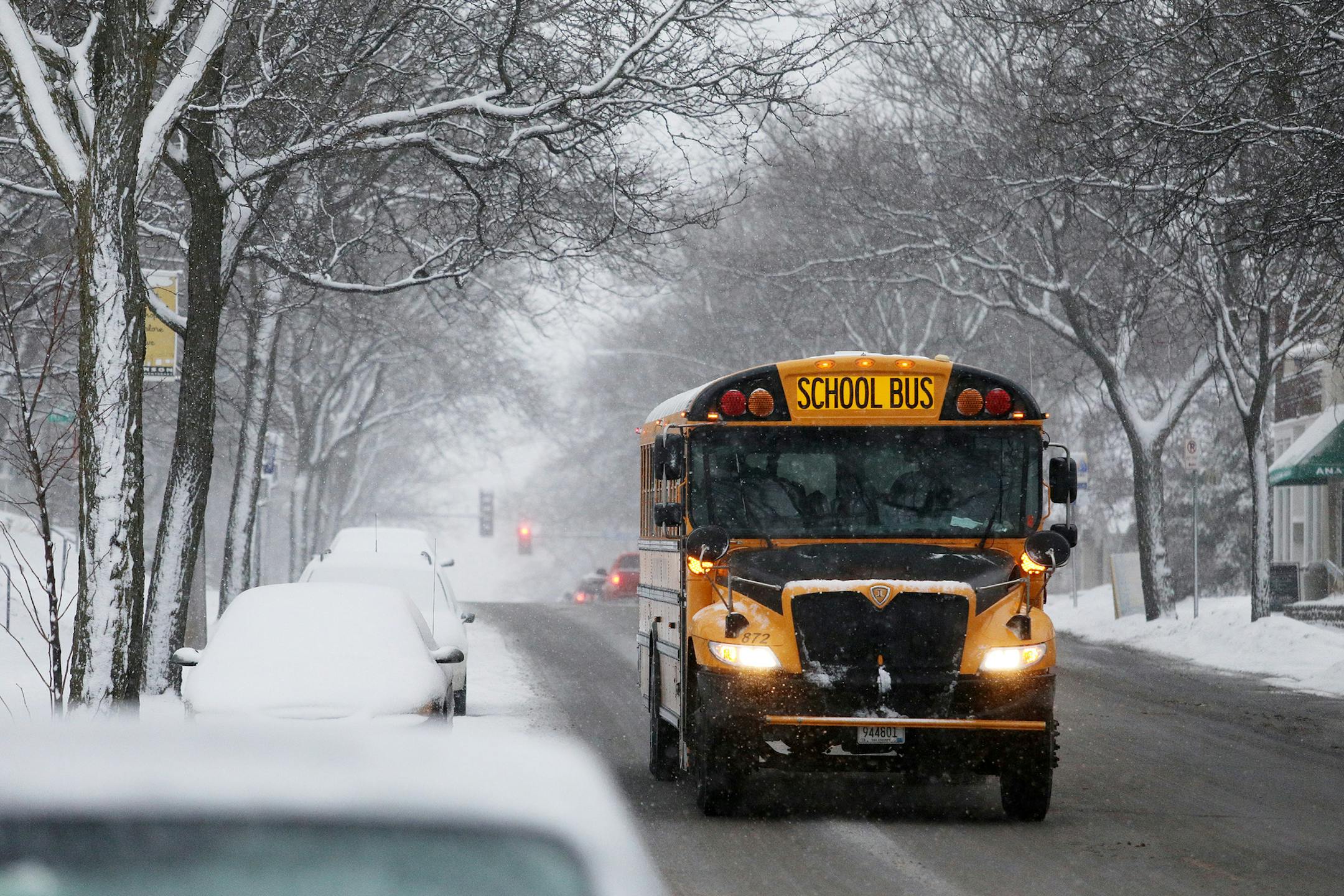 A school bus drove north on Johnson Street North East amid a flurry of snowflakes Wednesday morning. ] ANTHONY SOUFFLE &#x2022; anthony.souffle@startribune.com Commuters woke up to a snow covered landscape as a morning snow blanketed the area Wednesday, Jan. 24, 2017 in Minneapolis.