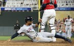 Cleveland Indians' Oscar Mercado slides safely into home to score on a sacrifice fly by Yasiel Puig against the Minnesota Twins to tie the score durin