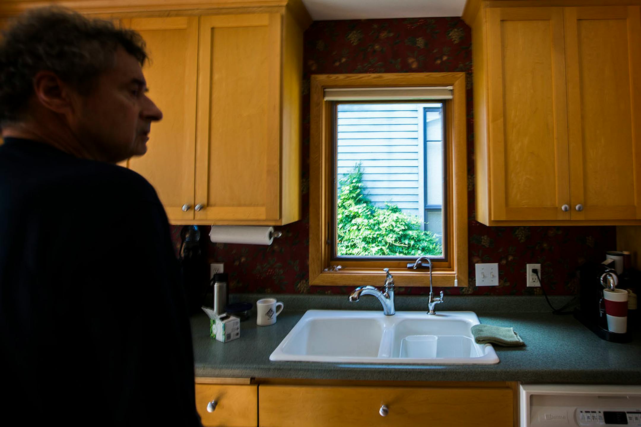 Shuster's kitchen window used to offer a view of neighboring backyards. Now it looks directly into his neighbor's house.