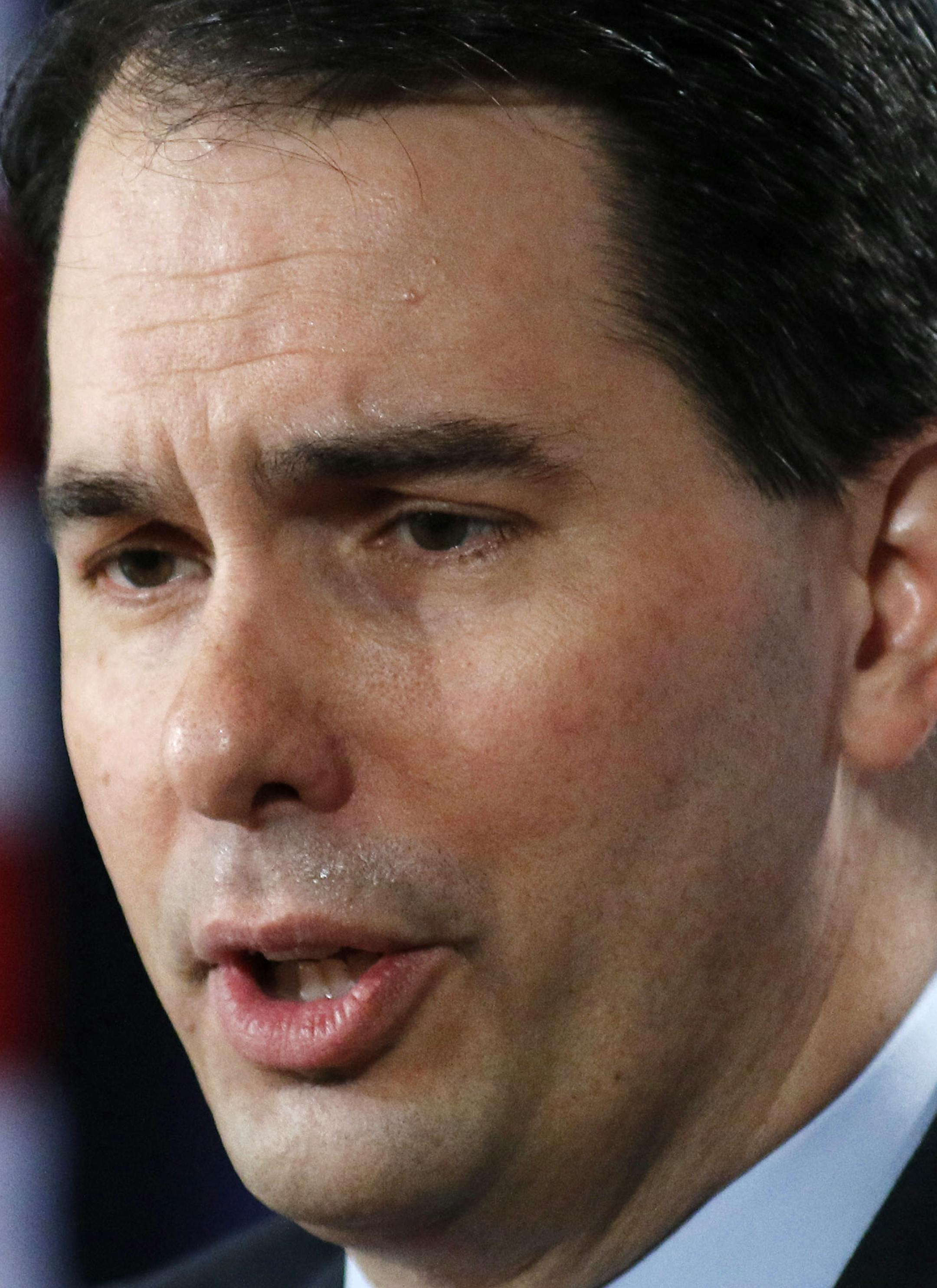 FILE - In this Feb. 28, 2015 file photo, Wisconsin Gov. Scott Walker speaks in Palm Beach, Fla. Walker has transformed Wisconsin politics, winning three elections in four years and signing laws that weaken unions, crippling a key component of the Democratic Party. But the likely Republican presidential contender has had less success changing Wisconsin’s economy and budget. The state lags in job growth and its budget faces a shortfall. It’s a record that complicates Walker’s