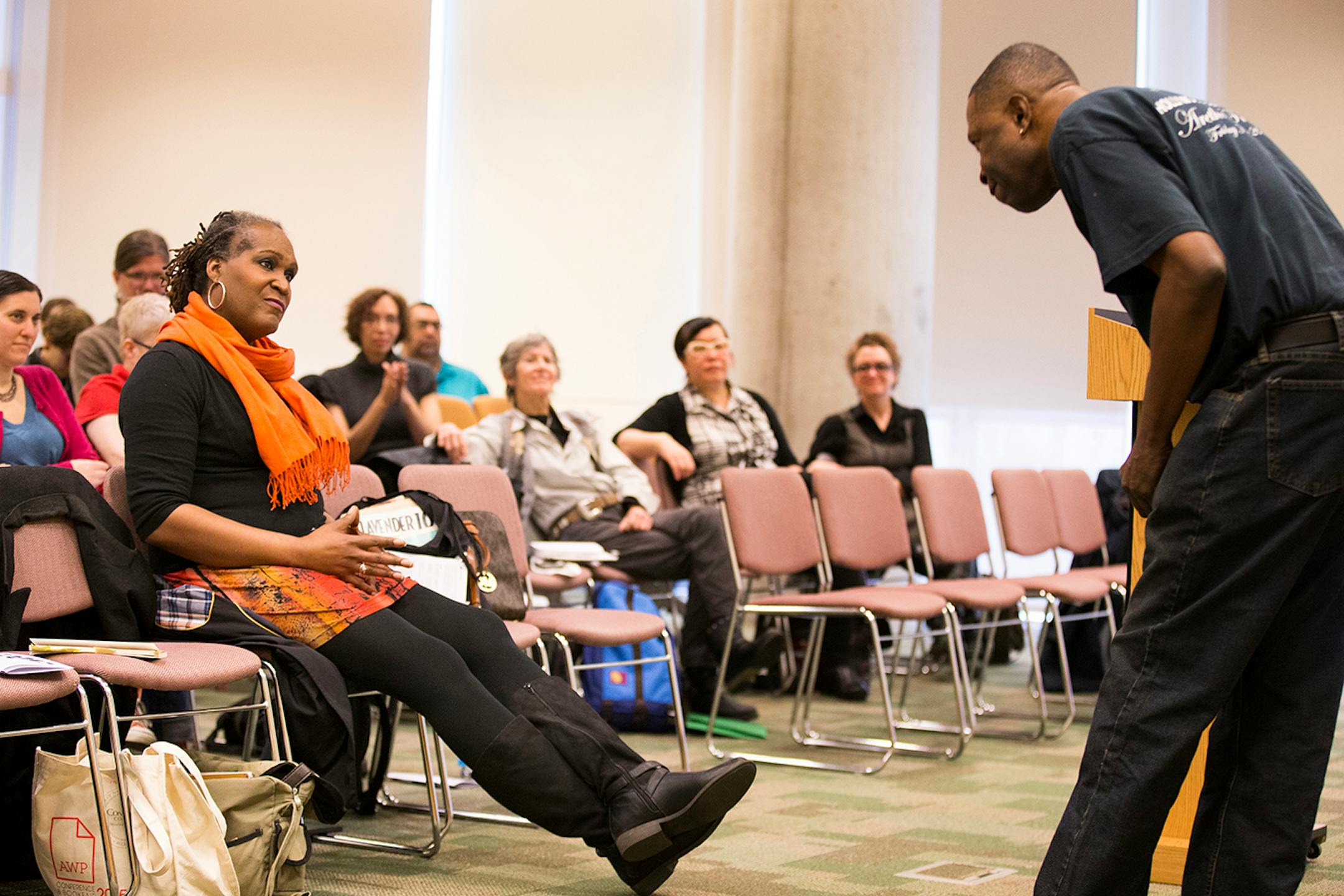 Local writer Andrea Jenkins, left, watches performance artist Levan Hawkins during Queer Voices, an event she co-curated to bring together LGBT poets and writers as part of the Association of Writers & Writing Conference, at the Minneapolis Central Library in downtown Minneapolis on Thursday, April 9, 2015. ] LEILA NAVIDI leila.navidi@startribune.com /