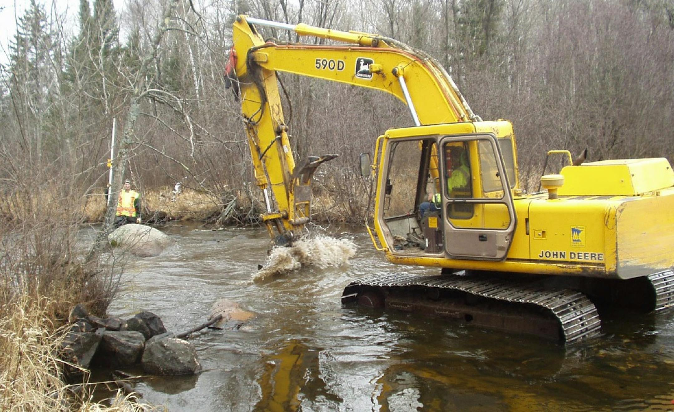 A backhoe excavates rocks in the Dark River in northern Minnesota in 2005. This incident was one of two incidents that David Holmbeck has investigated relentlessly ever since.