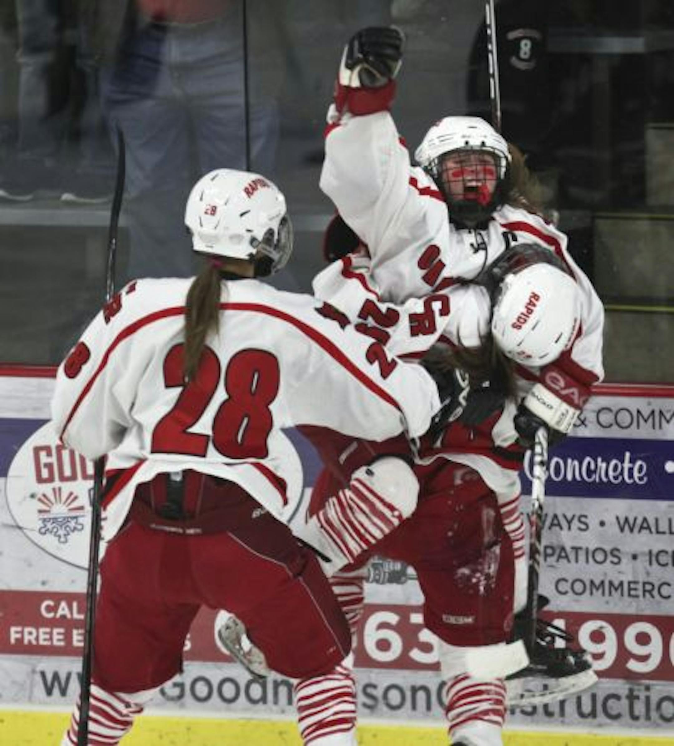 Rachael Bona, center, celebrated with teammates Katie Wolter, left, and Brenna Paskey after scoring the first of her three goals against Anoka in the Class 2A, Section 5 championship game.