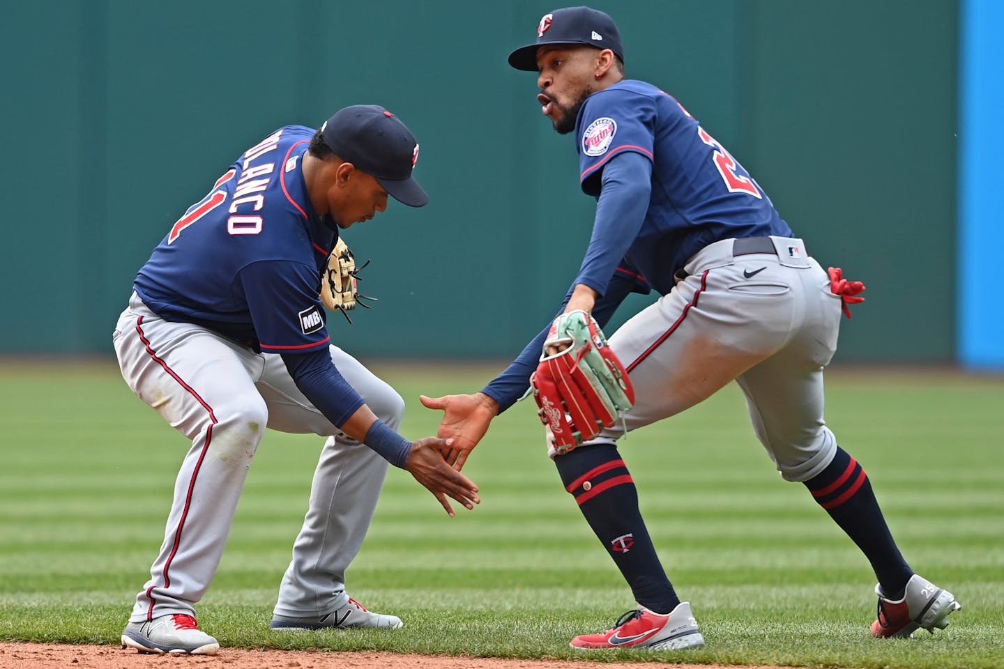 Minnesota Twins' Byron Buxton (right) and Jorge Polanco (left) celebrate after the Twins defeated the Cleveland Indians 10-2 in a baseball game, Wednesday, April 28, 2021, in Cleveland. (AP Photo/David Dermer)