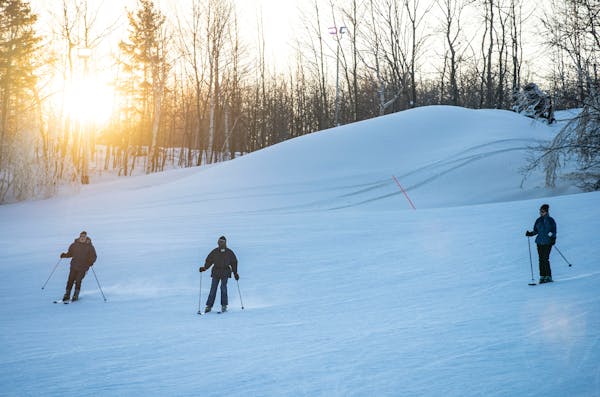 A group of skiers made their way down a Spirit Mountain run at sunset in 2019. Spirit Mountain is poised to get a $1.25 million grant to improve Nordi