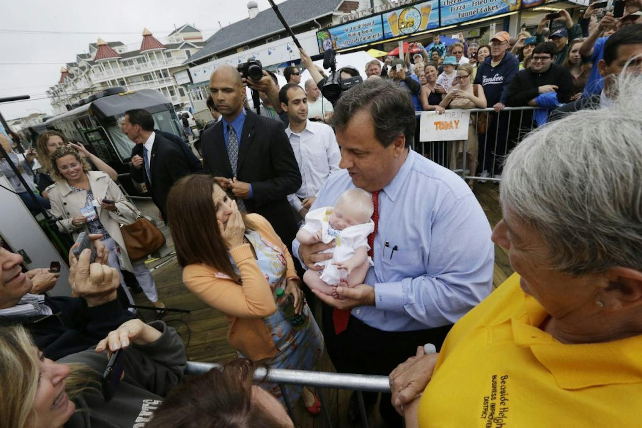 New Jersey Gov. Chris Christie, right, holds 6-week-old Willow DeParre, as first lady Mary Pat Christie looks on as they greet people during the opening of the New Jersey shore, Friday, May 24, 2013, in Seaside Heights, N.J. Christie cut a ribbon to symbolically reopen the state's shore for the summer season, seven months after being devastated by Superstorm Sandy. Several beach communities have annual beach ribbon cuttings, announcing they are back in business. But this year's ceremonies are mo