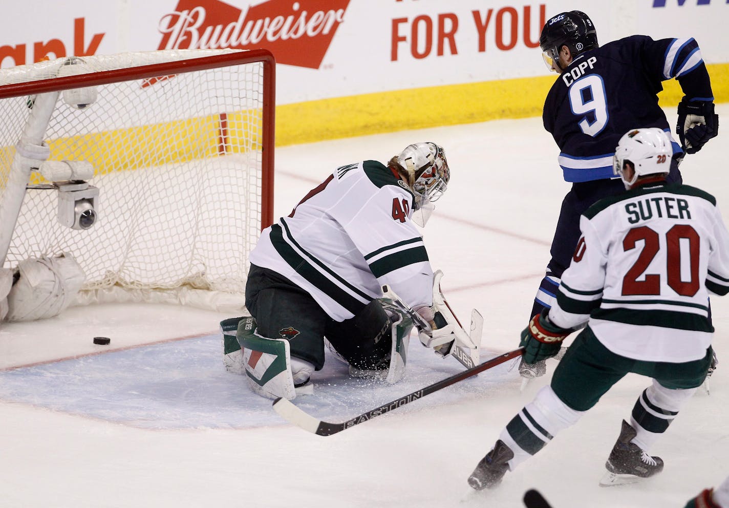 The Jets' Andrew Copp (9) scored on Wild goaltender Devan Dubnyk as defenseman Ryan Suter trailed the play during the third period in Winnipeg on Sunday.