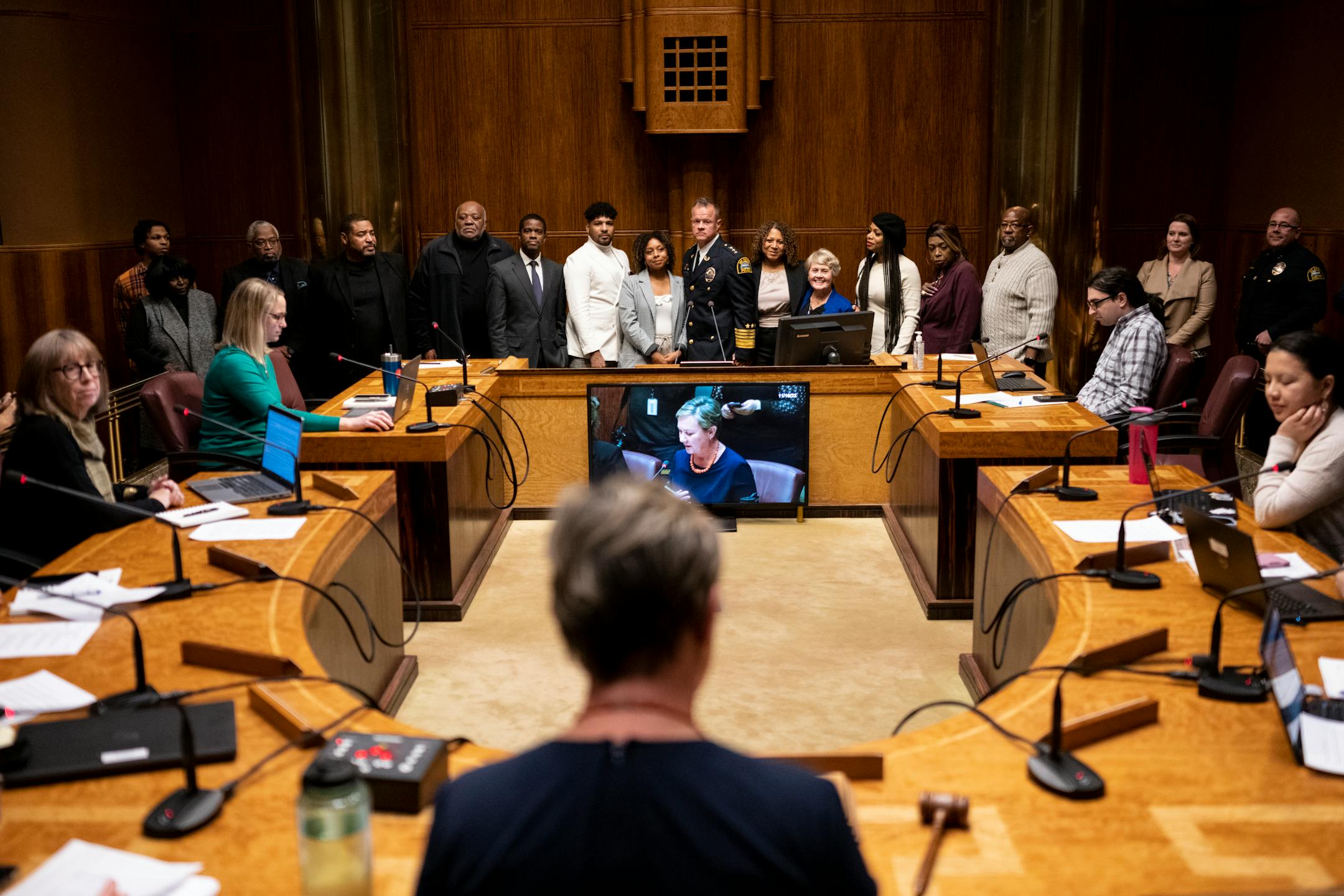 St. Paul Police Commander of Narcotics, Financial Intelligence and Human Trafficking Division Axel Henry, back center, stands with his family as the St. Paul City Council votes on his confirmation as the city's new police chief Wednesday, Nov. 16, 2022 at St. Paul City Hall in St. Paul, Minn..