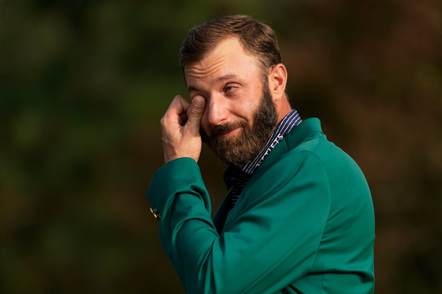 Masters champion Dustin Johnson wipes away a tear while being interviewed following his victory Sunday