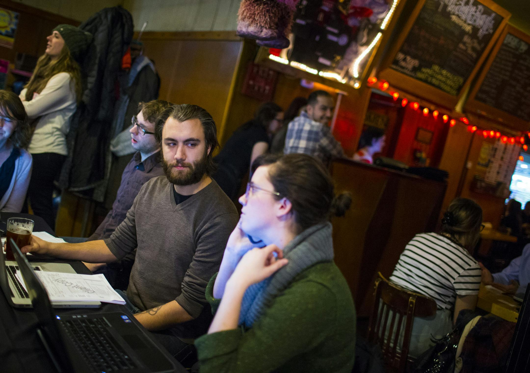 Nolan Morice got assistance from MNsure navigator Ally Lynne as he worked through enrolling at a MNsure event "Bowling for Health Insurance" at the Bryant Lake Bowl in Minneapolis, Minn. on Tuesday, February 3, 2015. This was an outreach strategy, originally geared to the GLBT community, to get people into coverage by the Feb. 15 close of open enrollment through the MNsure health insurance exchange. ] RENEE JONES SCHNEIDER • reneejones@startribune.com