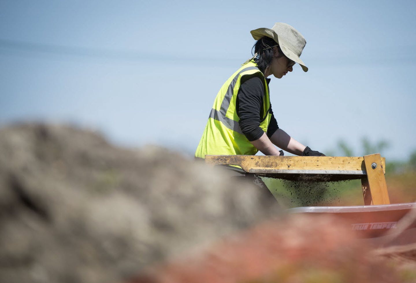 Hamline University alumna Desiree Haggberg used a screener to check for remains at the site of Native American burial mounds in Minnetonka in May 2015.