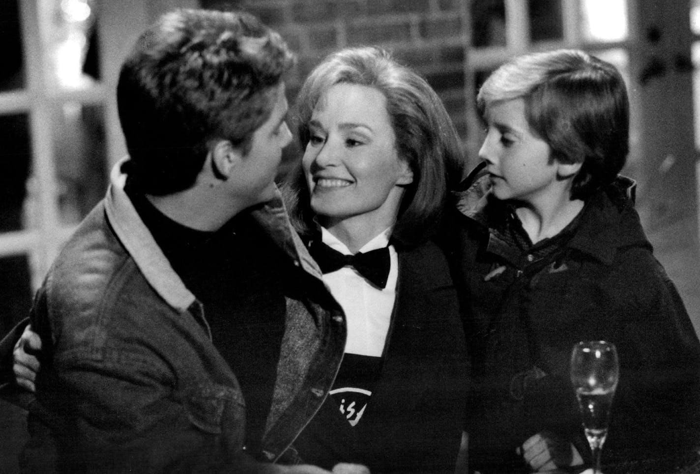 March 4, 1994 Beth (Jessica Lange) and her sons Chris (Chris O'Donnell, left) and Matt (Charlie Korsmo) share their happiness with a New Year's Eve celebration in a Geffen Film Company release, "Men Don't Leave," distributed by Warner Bros.