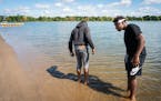 Devaughn Barnes, 18, dips his toes into the water at Lake Nokomis Beach while on a school field trip Friday, Sept. 6.