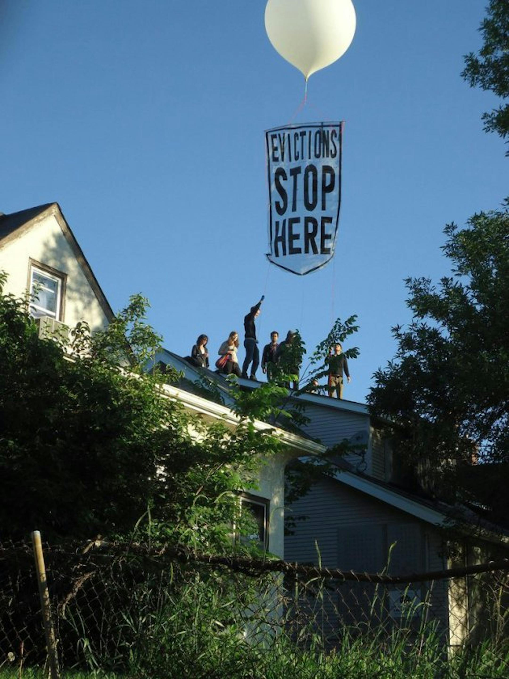 Protesters deploy balloon banner over Cruz house. Photo courtesy of Occupy Homes MN