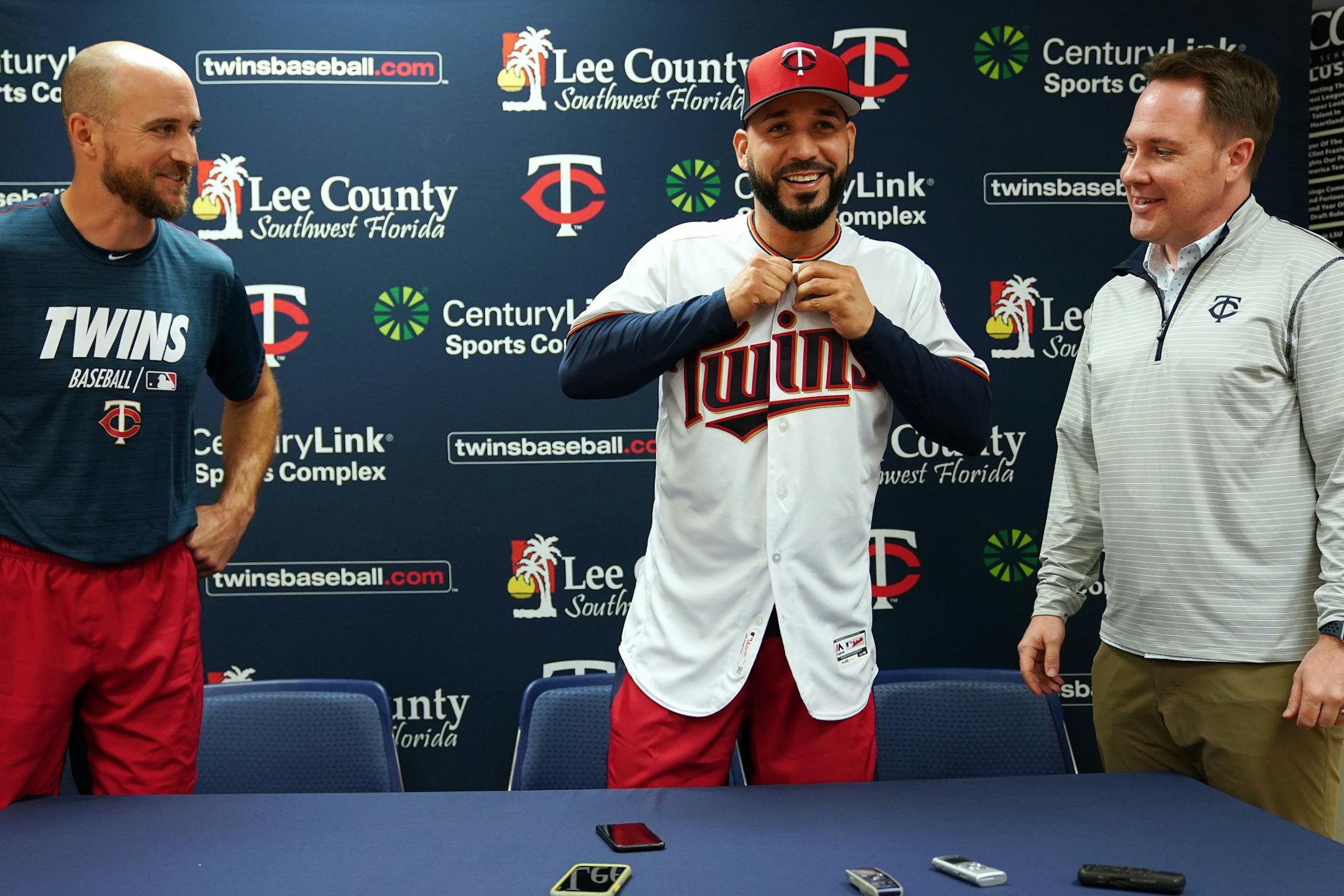 Marwin Gonzalez (9) stood between Minnesota Twins Manager Rocco Baldelli (5) and Minnesota Twins Chief Baseball Officer Derek Falvey as he got his new jersey following a press conference to announce the utility player's signing Monday morning.