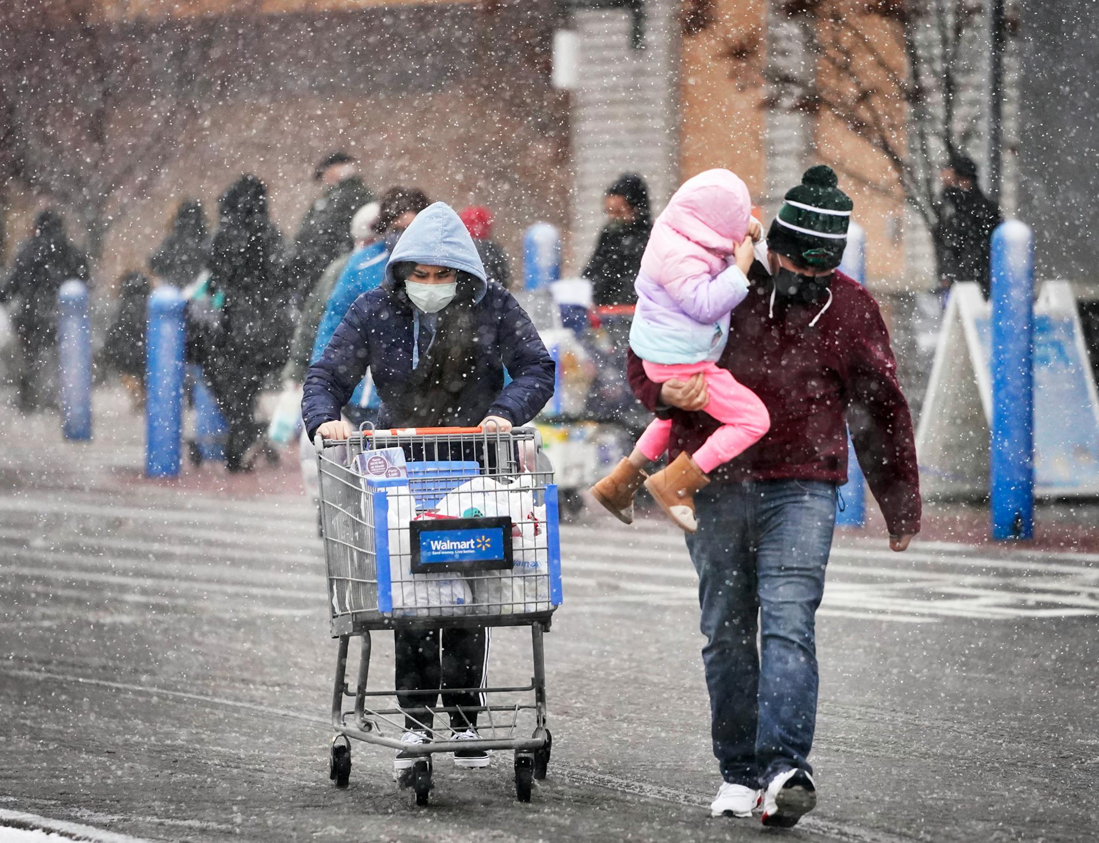 Shoppers endured snowy conditions while getting  groceries before the holidays  Wednesday at Walmart in Bloomington before a full-blown blizzard was expected.