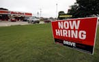 FILE- In this Sept. 27, 2018, file photo a bilingual help wanted sign for Auto Zone is posted outside the store in Canton, Miss. Against the backdrop 