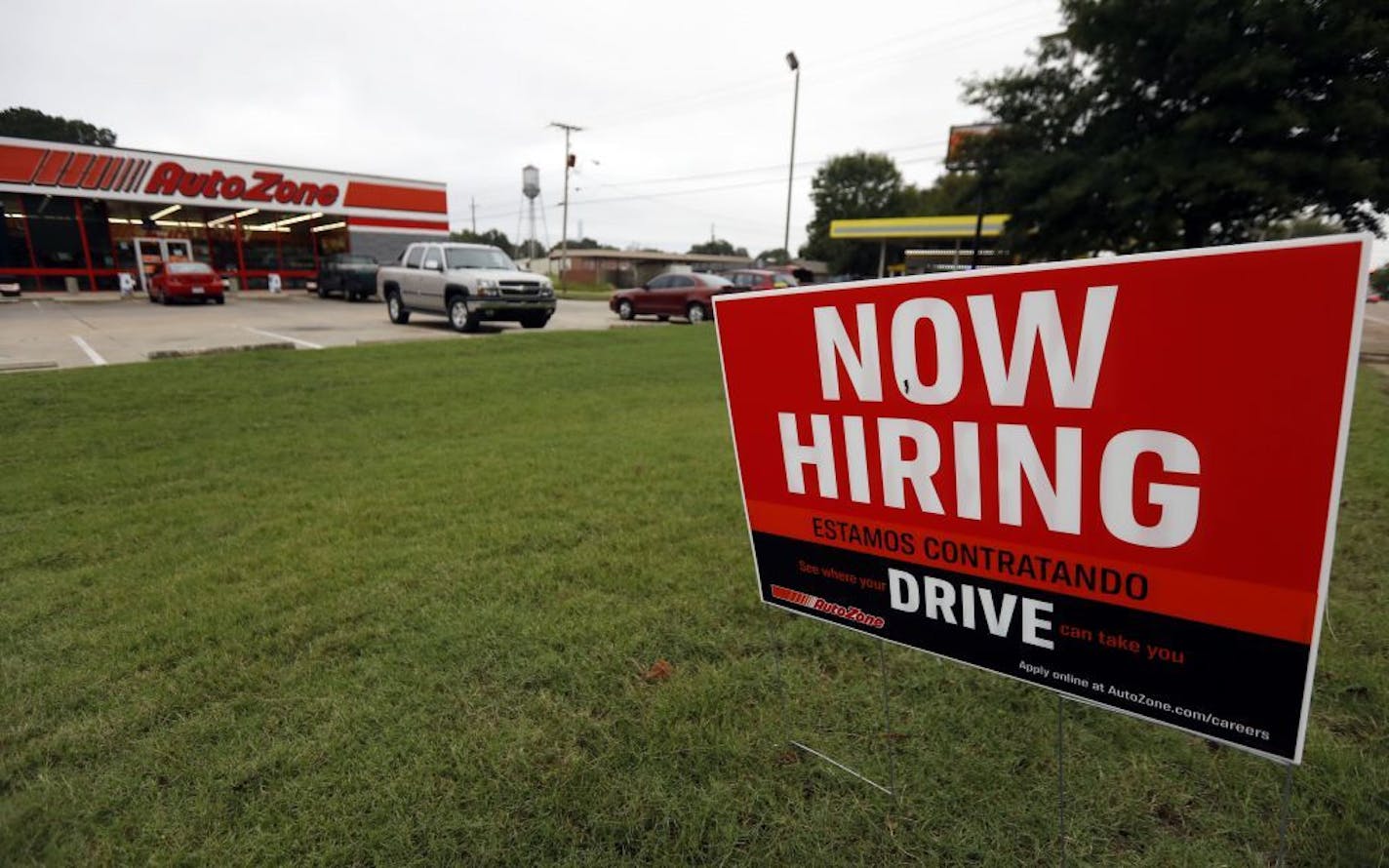 FILE- In this Sept. 27, 2018, file photo a bilingual help wanted sign for Auto Zone is posted outside the store in Canton, Miss. Against the backdrop of next week's midterm elections, the U.S. job market is the healthiest it's been in at least two decades. And with another strong hiring report expected Friday, Nov. 2, some barometers of the job market suggest that it has room to strengthen further.