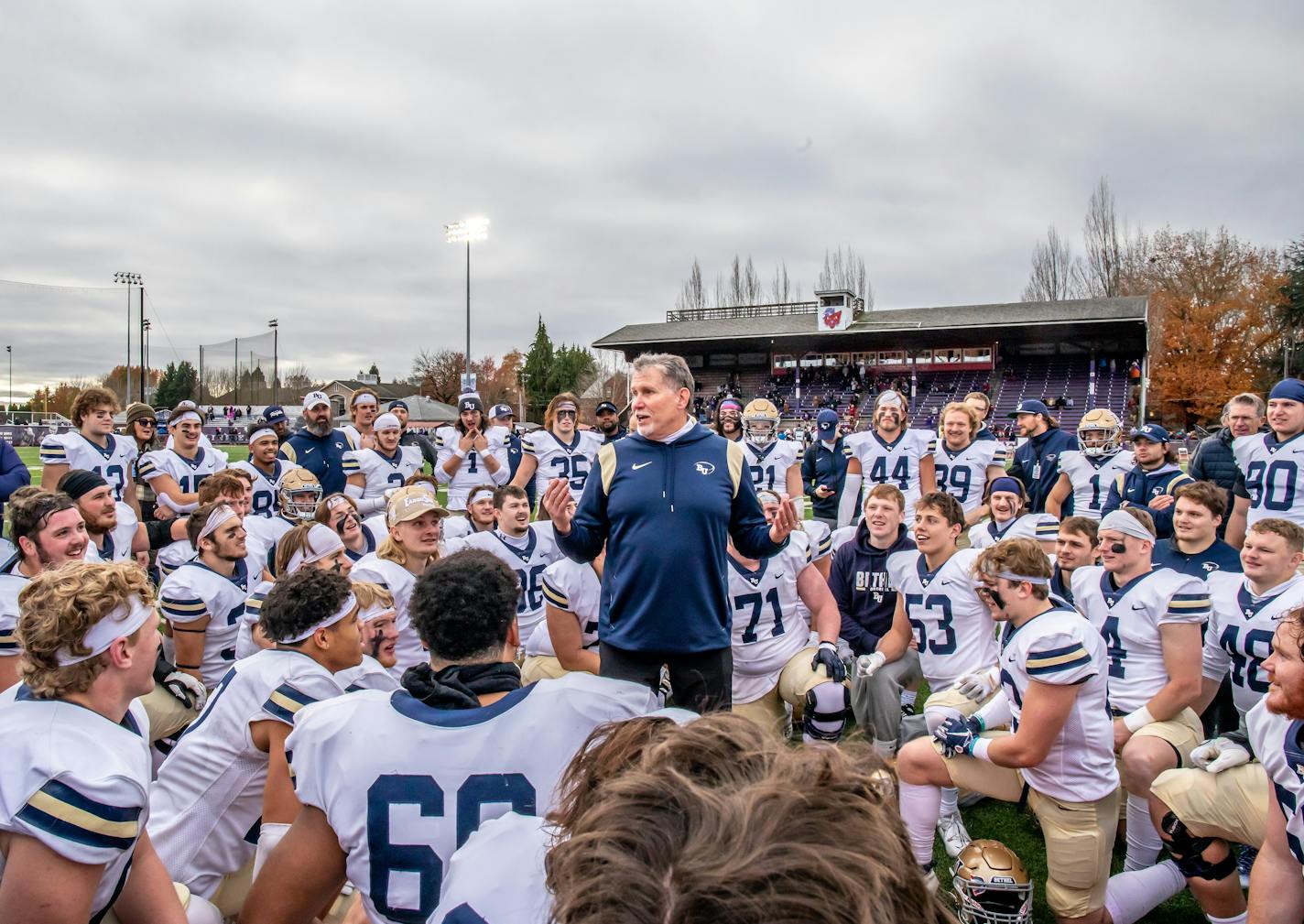 Bethel football coach Steve Johnson addressed his team after their playoff victory Nov. 26, 2022. Bethel University photo.