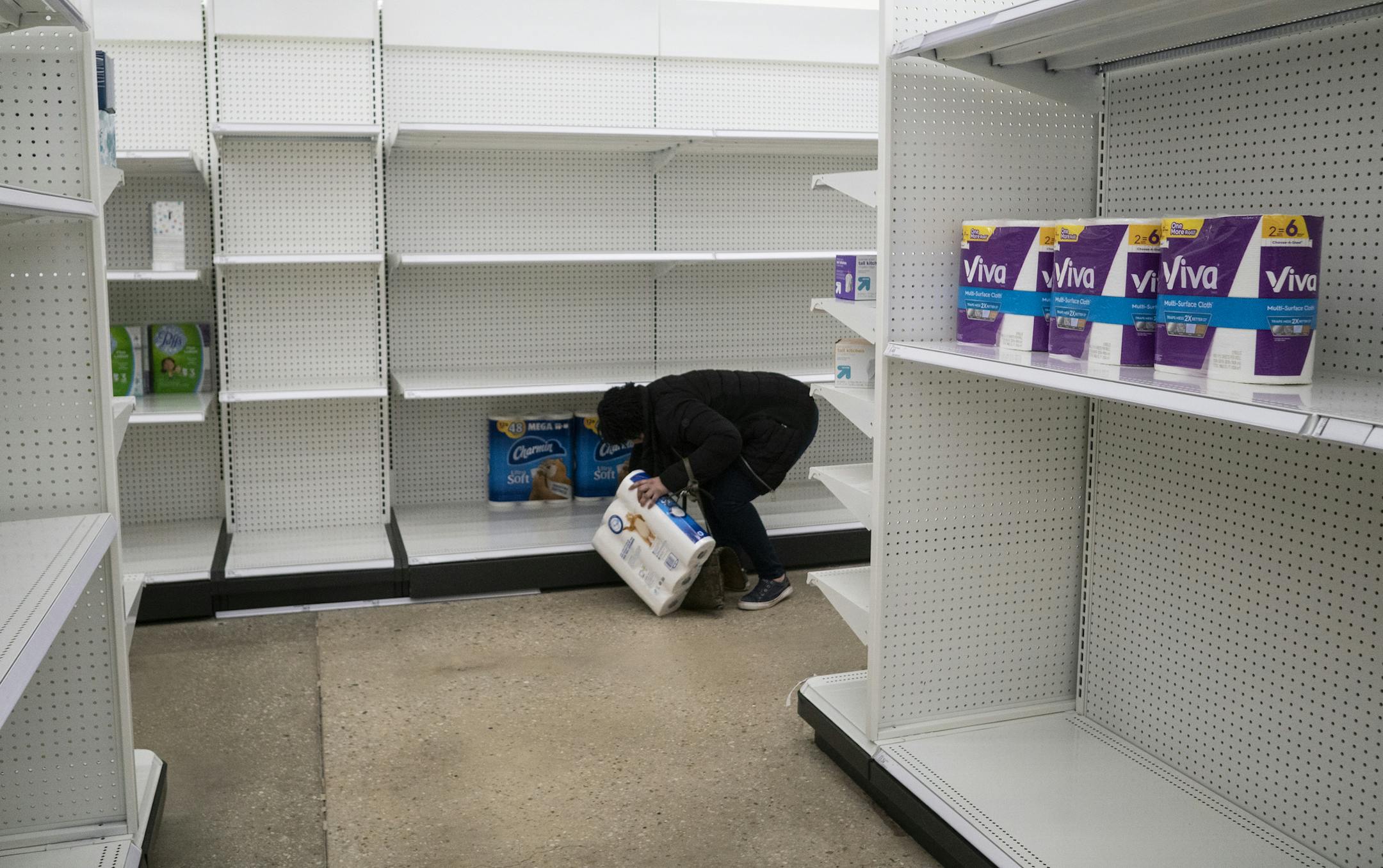 An example of zero-risk bias, the notiont that, in an uncertain time, people will feel better if they eliminate some risk altogether. A shopper reaches for one of the last packages of toilet paper at Target store in Washington, D.C., earlier this week.