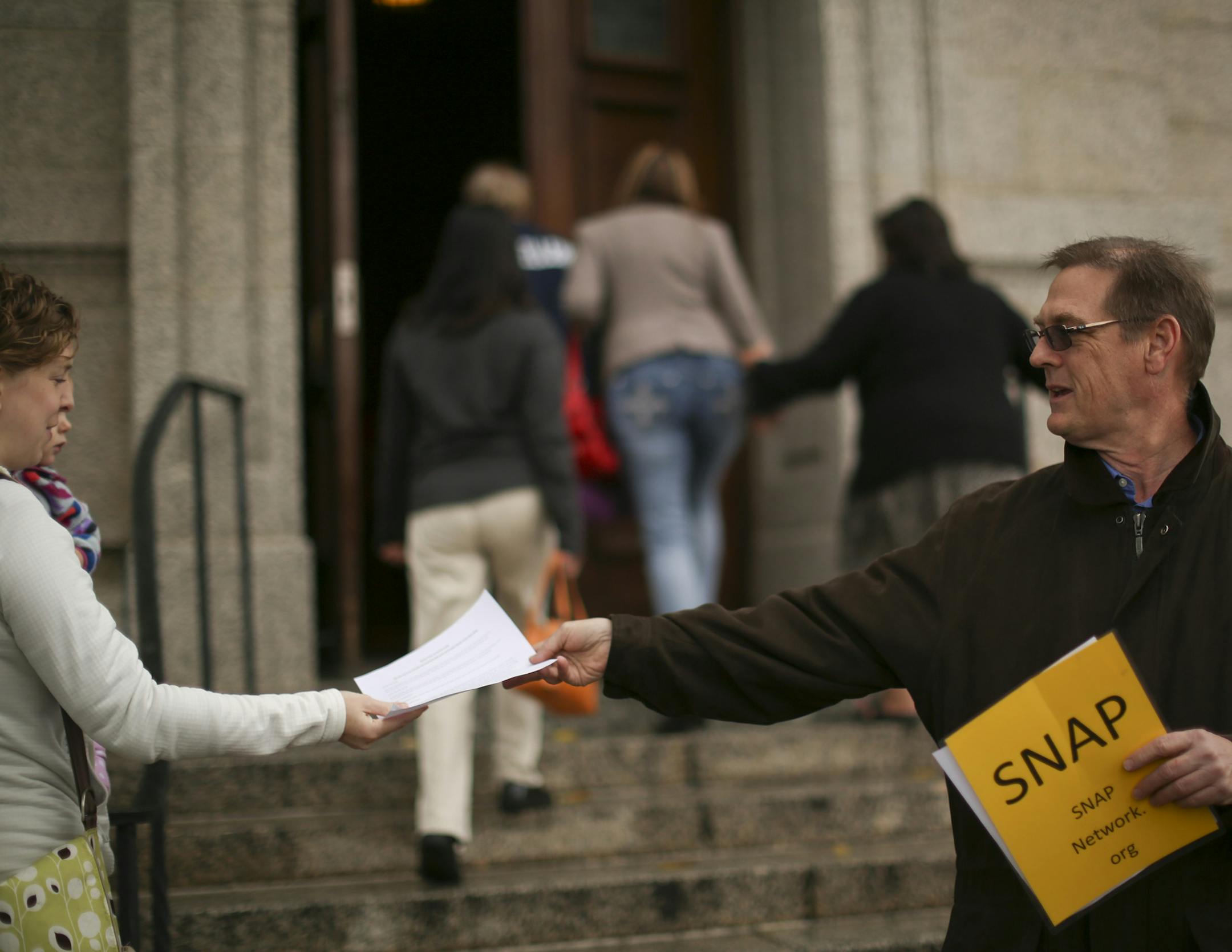 David Clohessy, executive director ofSNAP, the Survivors Network of those Abused by Priests, offered informational leaflets to people entering the Cathedral of Saint Paul before the 5 p.m. mass Sunday evening, October 6, 2013 in St. Paul.