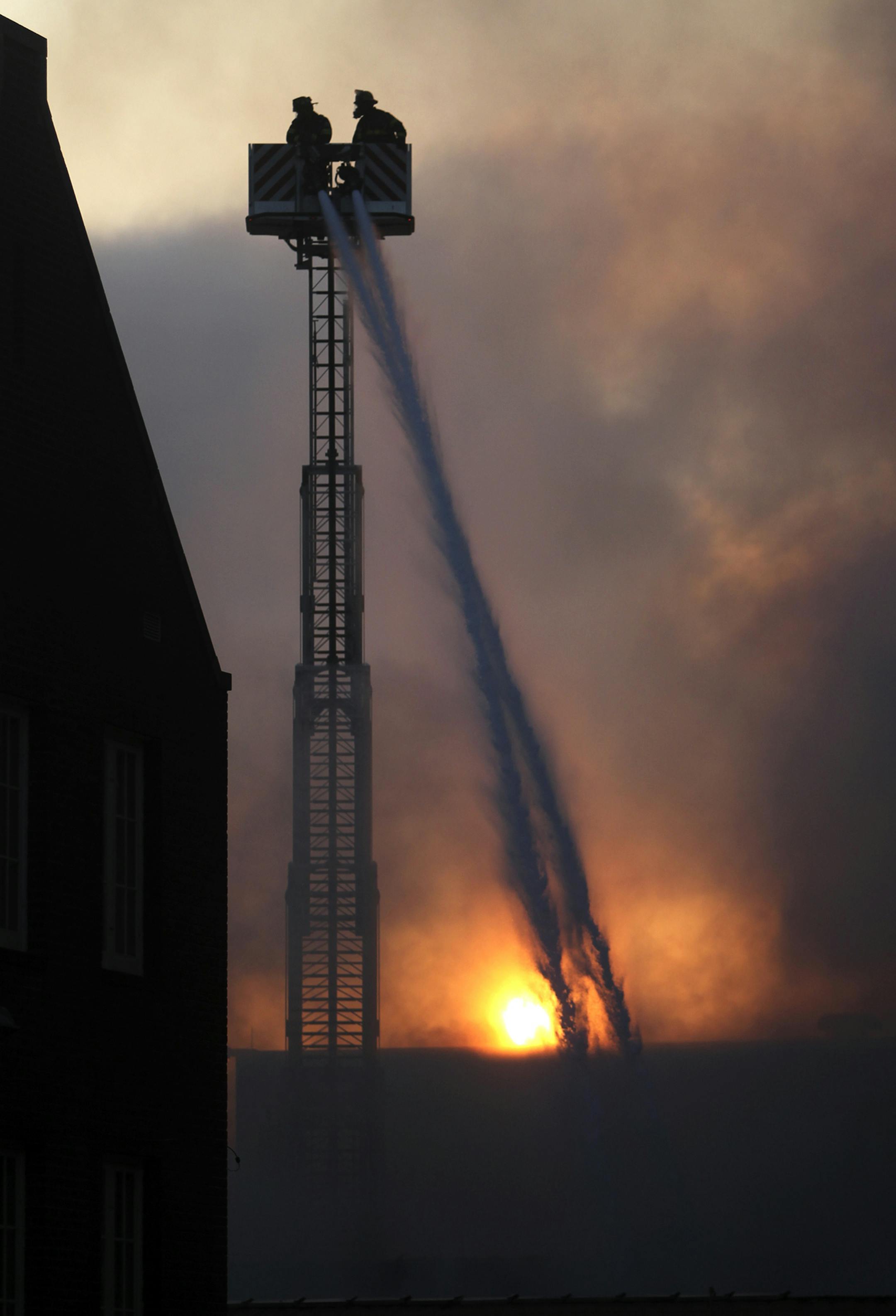 As the sun rises firefighters put water on a building housing a grocery and a deli along Chicago Avenue in south Minneapolis caught fire overnight and burned for several hours Thursday, April 25, 2013, in Minneapolis, MN.](DAVID JOLES/STARTRIBUNE) djoles@startribune.com Large fire at grocery store on Chicago Ave. S and 25 Street.