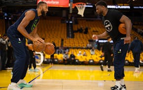 Timberwolves center Rudy Gobert does a dribbling drill with a trainer before they face the Golden State Warriors in Game 4 of their NBA Western Confer