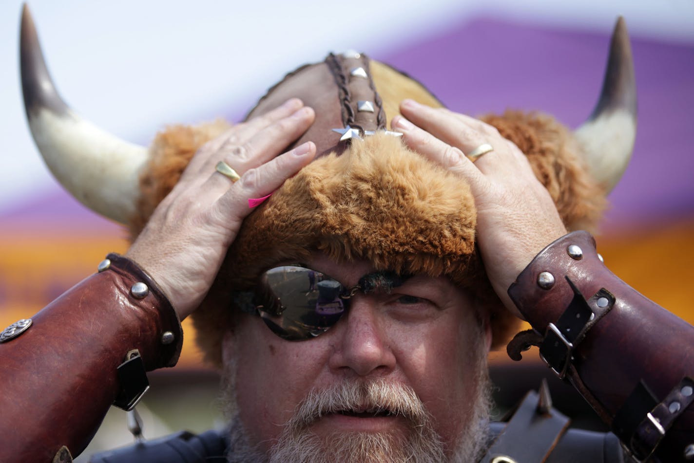 Greg Hanson adjusts his Viking costume before tailgating on Friday afternoon outside of TCF Bank Stadium. Hanson is known as "Sir Odin" in the Viking World Order, a group of loyal Viking fans.] Fans tailgate outside of TCF Bank Stadium on the University of Minnesota campus before the start of the Minnesota Vikings vs. Oakland Raiders pre-season game on Friday. The Vikings are playing in TCF Bank Stadium while their new stadium is constructed downtown. MONICA HERNDON monica.herndon@startribune.co