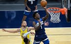 Minnesota Timberwolves forward Anthony Edwards (1) missed the layup but was fouled by Golden State Warriors guard Stephen Curry (30) for a chance at t